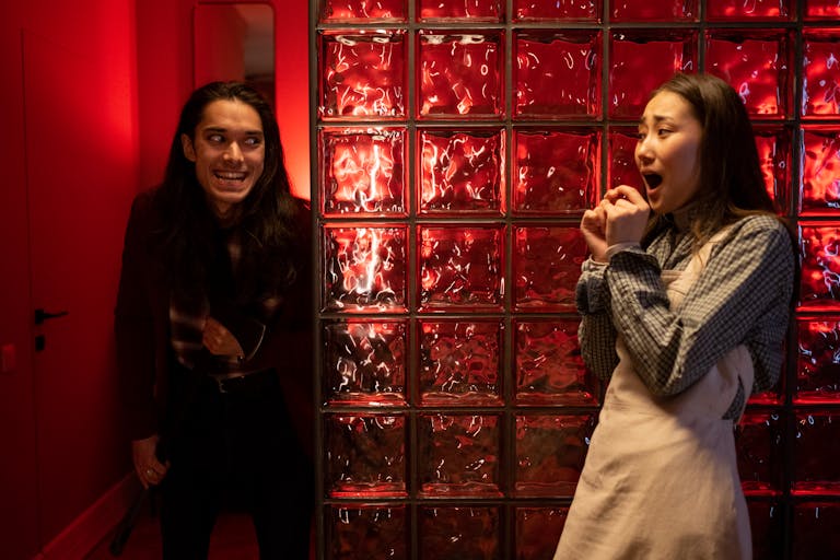 Wynonna Judd Performance Reactions A dramatic indoor scene with two teenagers showcasing surprise and suspense.