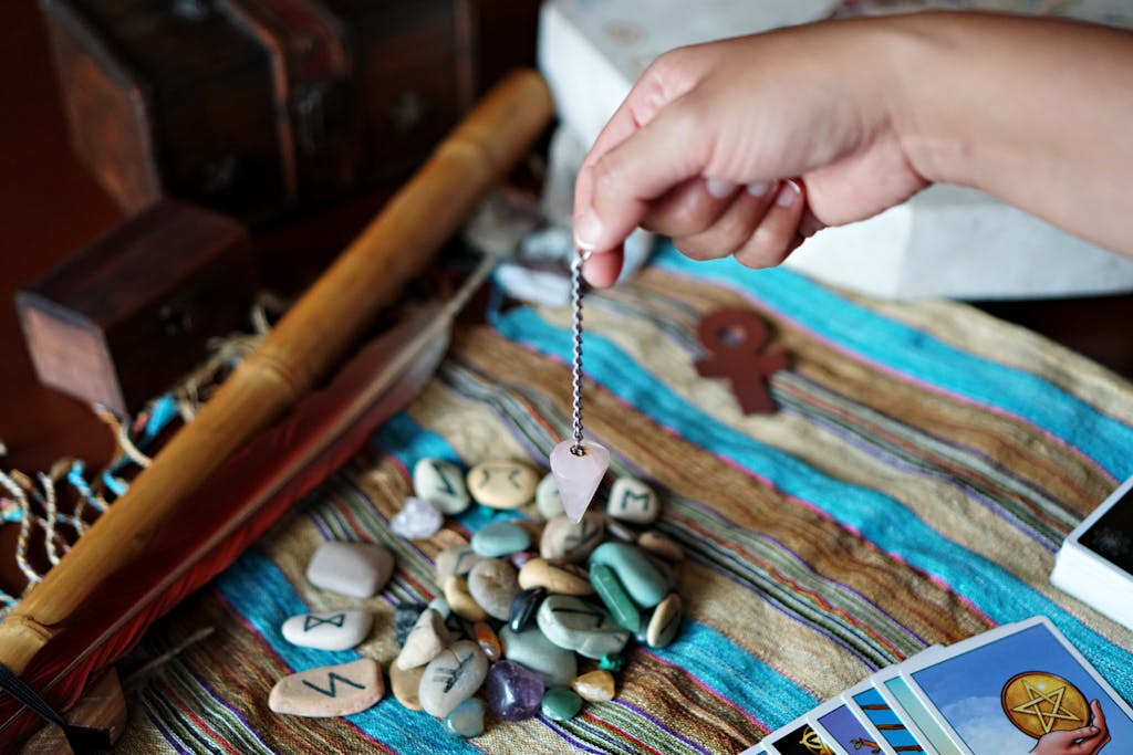 Nueraji vs Crosbie Prediction A mystical scene featuring a hand using a pendulum over runes and tarot cards.