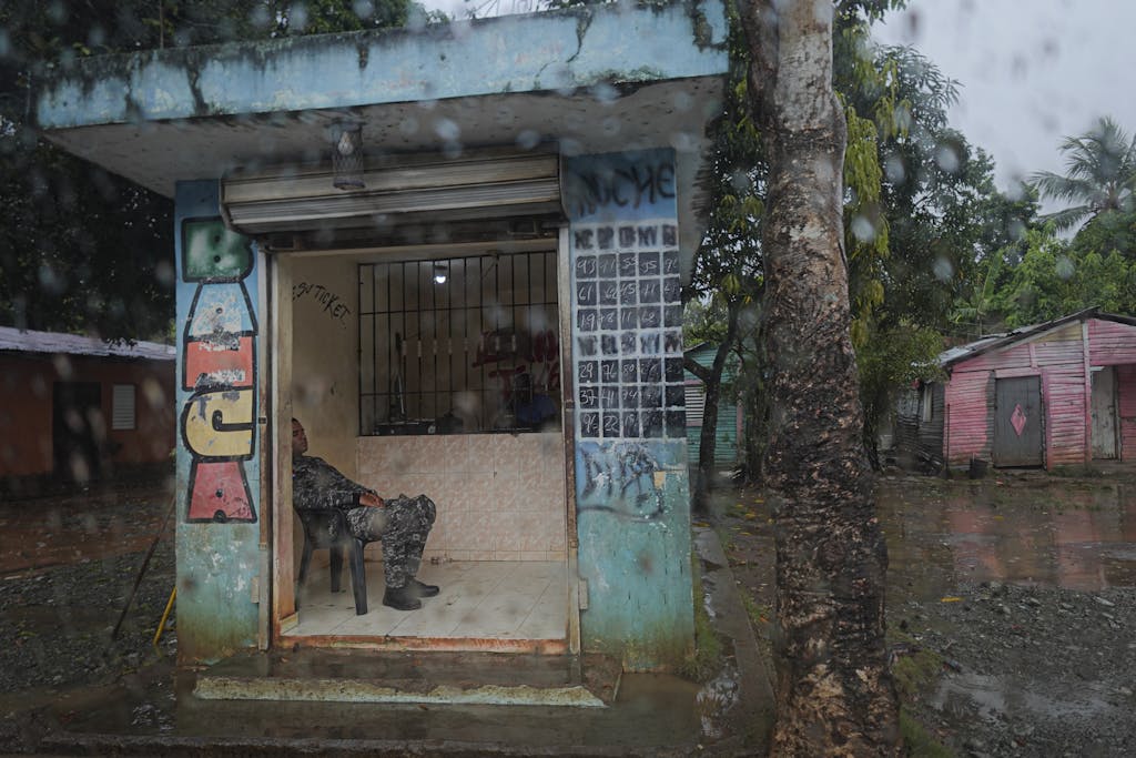 Florida Woman Wins Monopoly Lottery A soldier rests in a small guard post during a rainy day in an urban area.