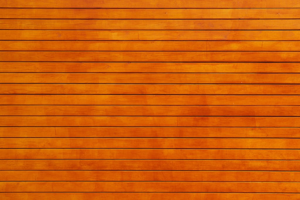 Virtusplays Close-up of a vibrant orange wooden wall texture, ideal for backgrounds.