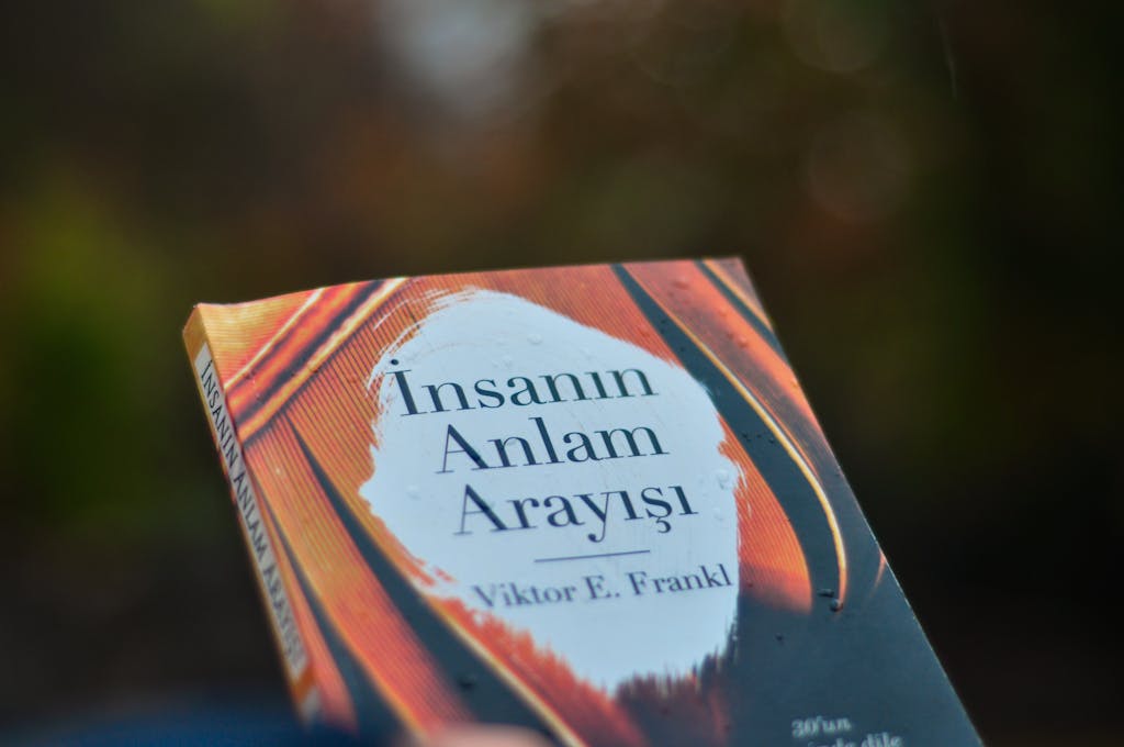 Newstook Close-up of 'Man's Search for Meaning' book cover by Viktor E. Frankl outdoors.