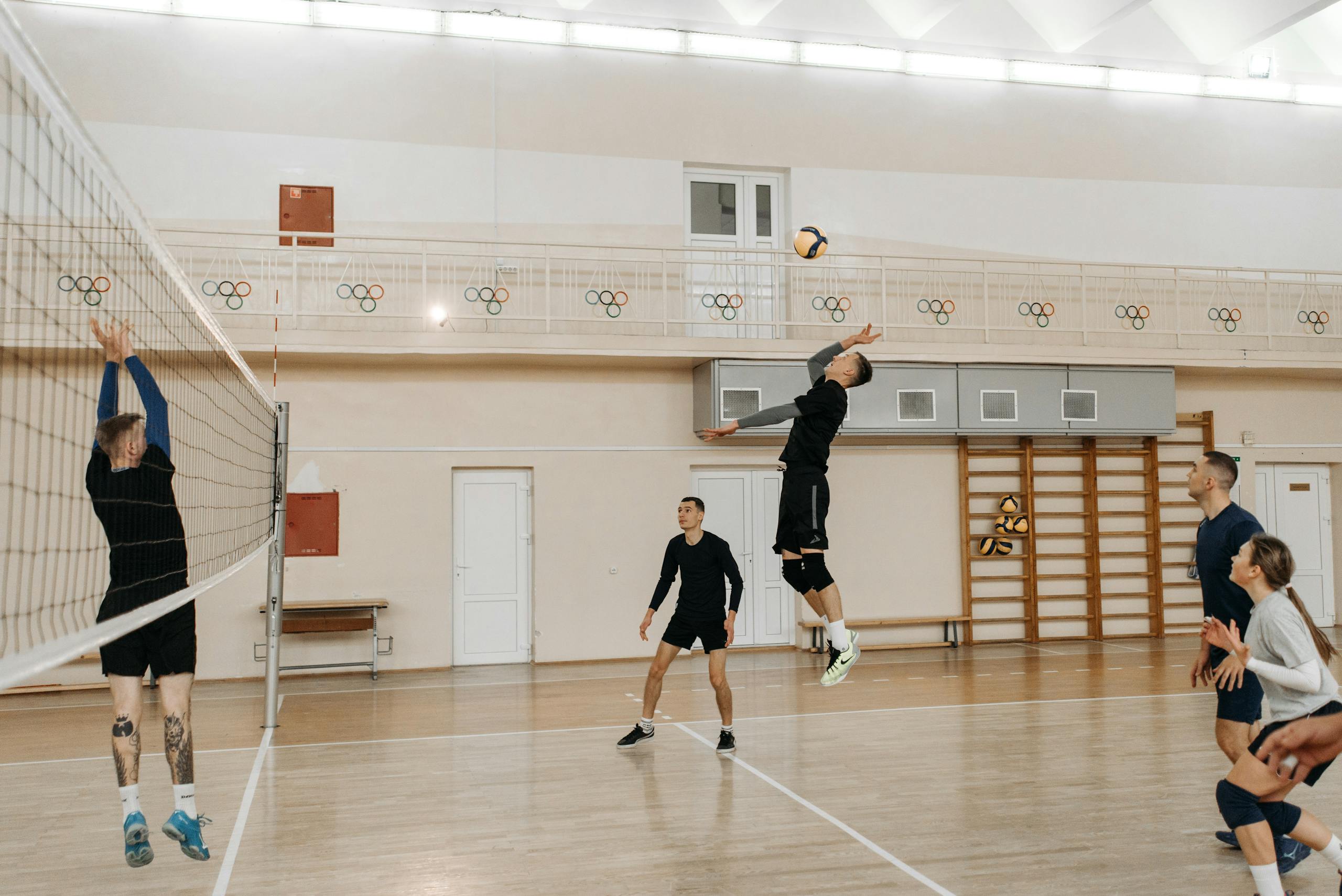 Chicago Cubs vs Miami Marlins Match Player Stats Competitive indoor volleyball match with athletes spiking the ball over the net.