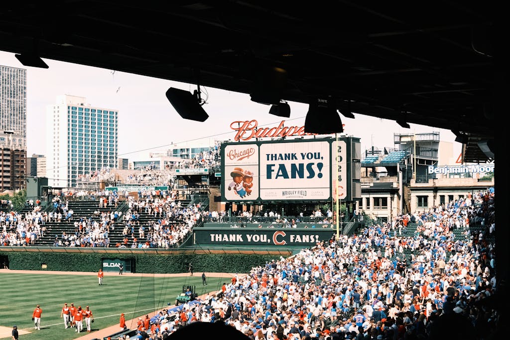 Chicago Cubs vs Miami Marlins Match Player Stats Crowd enjoying a baseball game at Wrigley Field, Chicago's iconic stadium, on a sunny day.