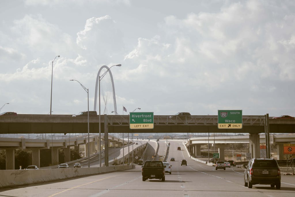 Texas Hunting Forum Daytime view of a busy expressway in Dallas, Texas featuring cars and road signs.