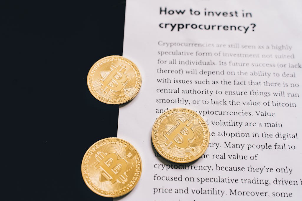 Whatsontech Gold Bitcoin coins on top of a cryptocurrency investment guide. High-quality finance and cryptocurrency image.