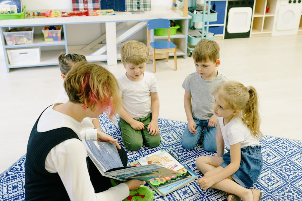JoinMyQuiz Group of children and a teacher reading together indoors at preschool.