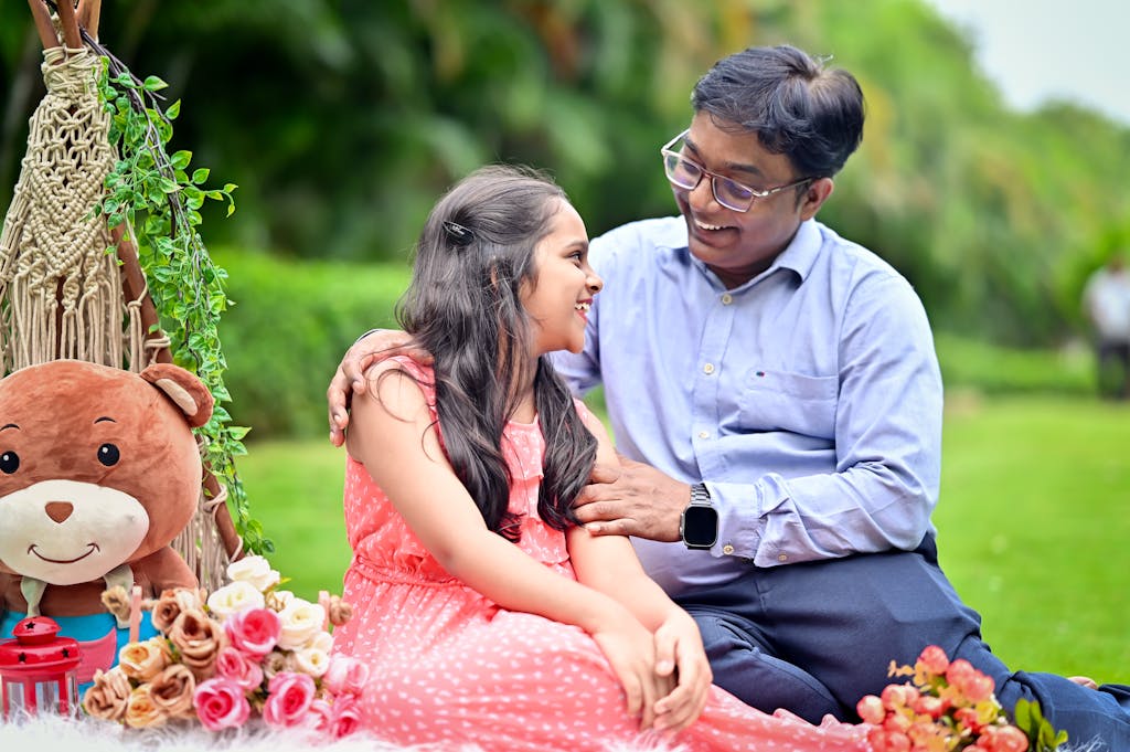 Bolly4u me Happy father and daughter bonding during a cheerful outdoor picnic in a garden.