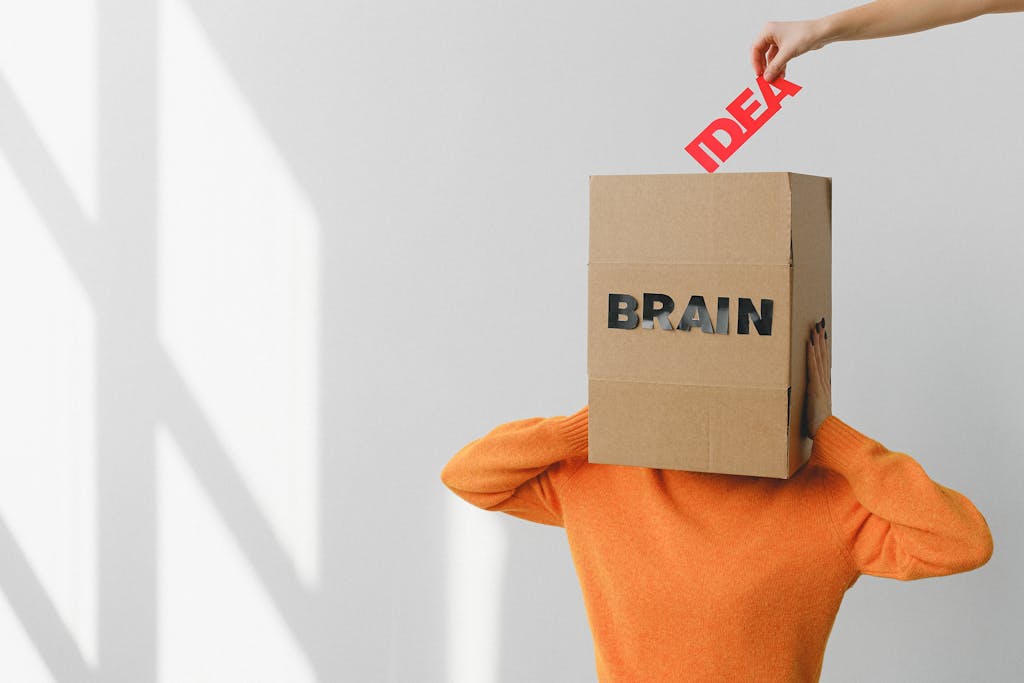 Newstook Surreal image of a person with a cardboard brain, symbolizing idea and intellect.