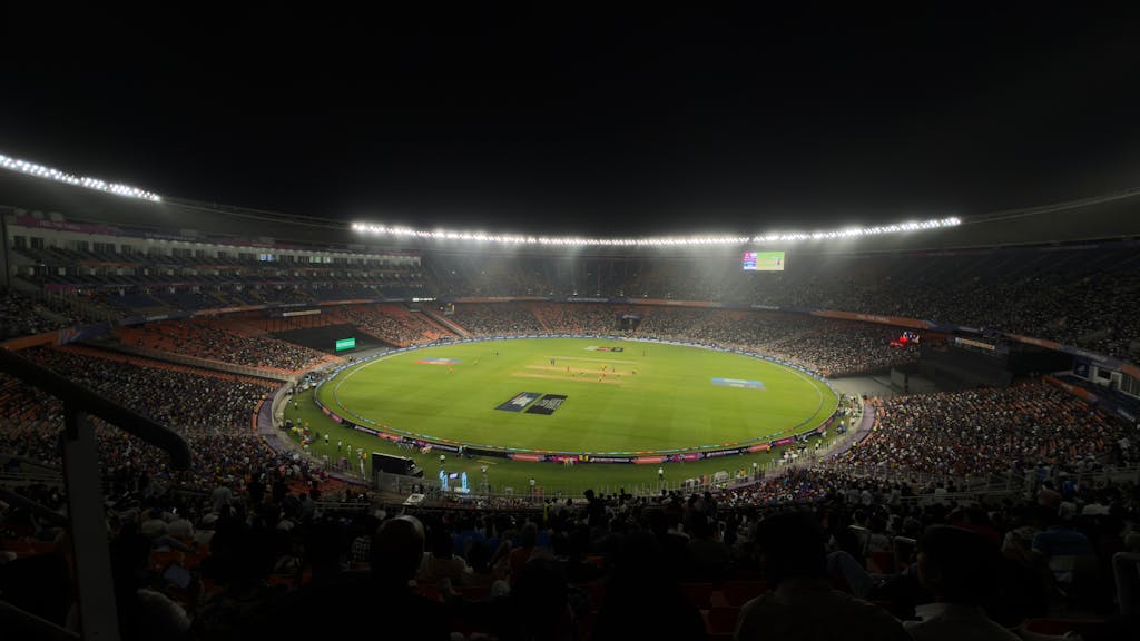 IPLLeague2026 A captivating night cricket match with a large crowd at Narendra Modi Stadium in Ahmedabad, India.