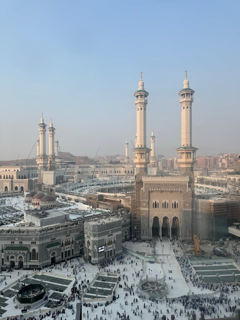 Car Subscription Saudi Arabia Aerial view of the Grand Mosque in Mecca, highlighting the majestic architecture and surrounding cityscape.