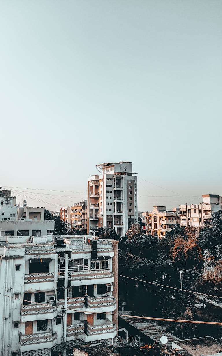 rajkot updates news Aerial view of urban apartment buildings with a clear sky, showcasing modern architecture.