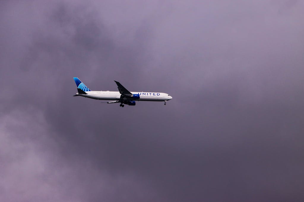 United Flight UA109 Diversion An airliner flying through a dramatic cloudy sky, capturing the essence of travel over Lisbon, Portugal.