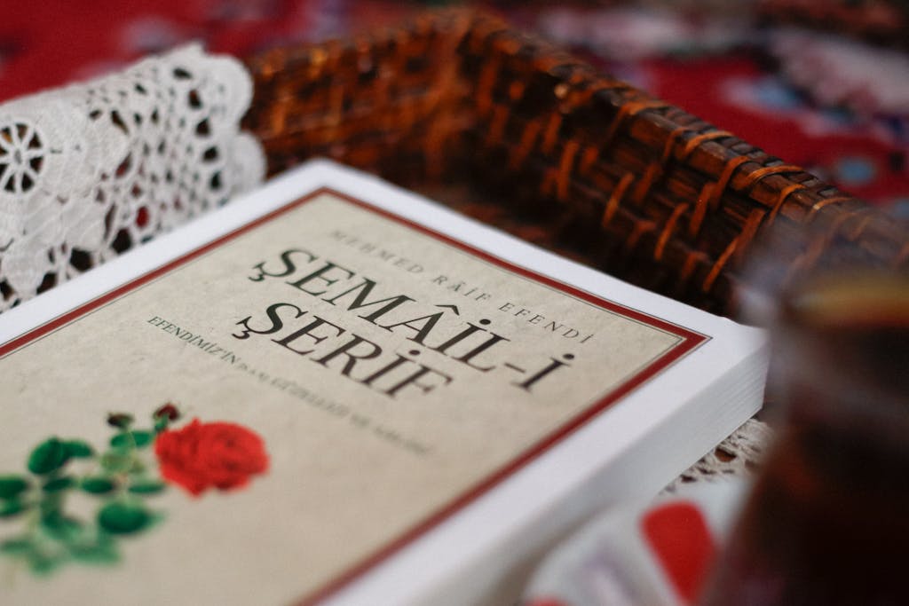 Serlig Close-up of the Semail-i Serif book with a woven basket and lace in the background.