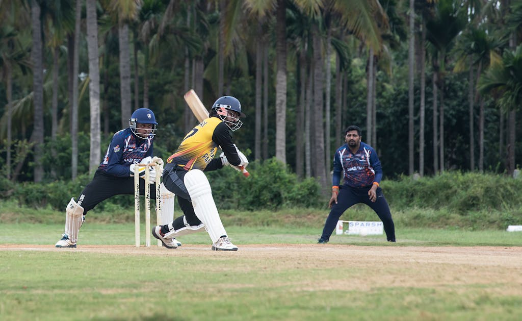 IPLLeague2026 Dynamic cricket action featuring a batsman playing a shot in a lush outdoor setting.
