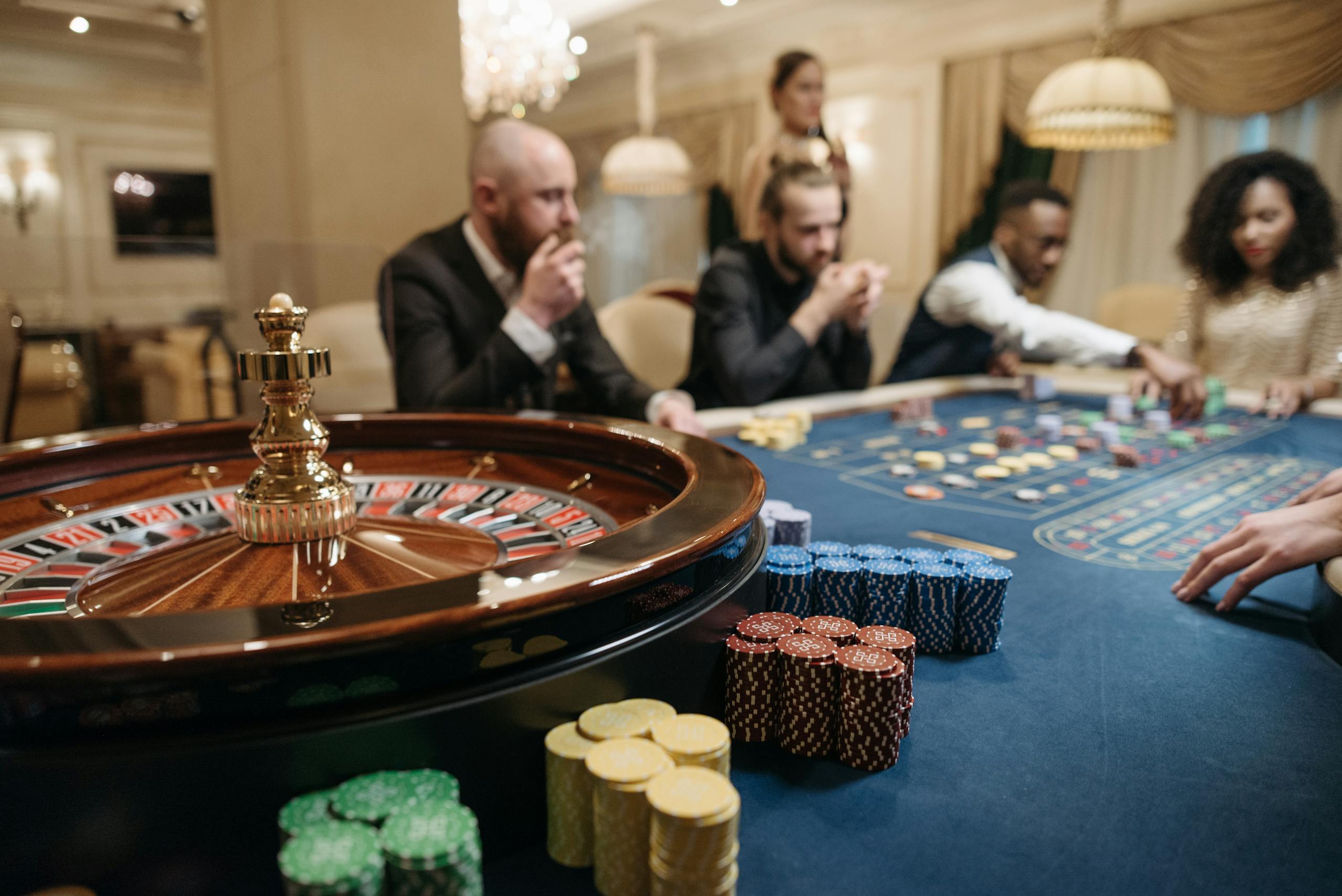 Norsk Casino People enjoying a roulette game in an upscale casino setting with chips and a roulette wheel.