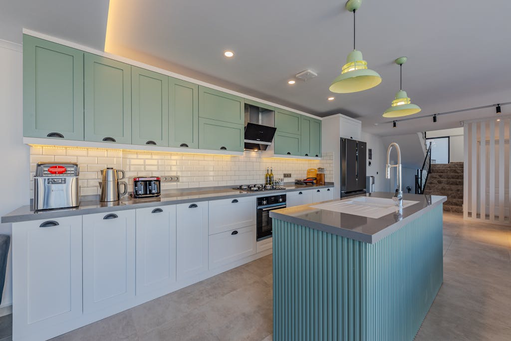 Memorandum to Cabinet Stylish kitchen featuring contemporary design, an island, and modern appliances.