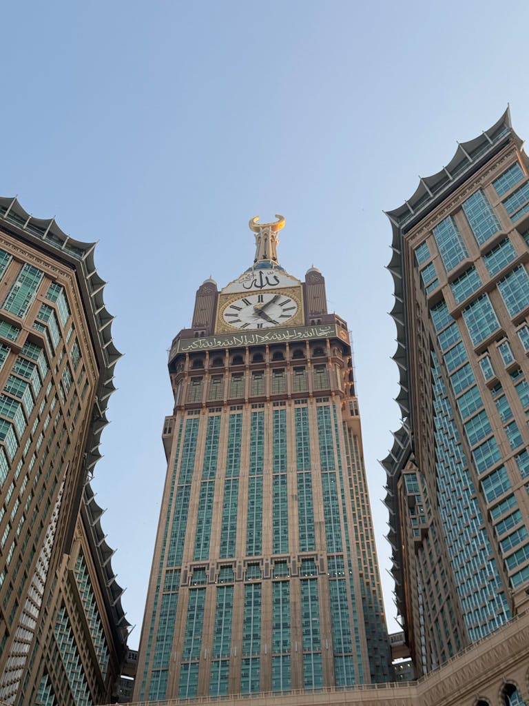 Car Subscription Saudi Arabia The grand Abraj Al Bait Towers reaching towards a clear blue sky in Mecca, Saudi Arabia.